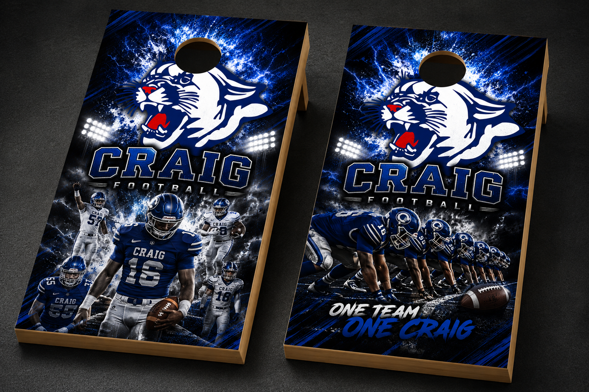 Two custom cornhole boards with a football theme, featuring a blue and white graphic design with the text 'CRAIG FOOTBALL', player photos, and a roaring wildcat mascot. The boards are displayed on a dark textured background.