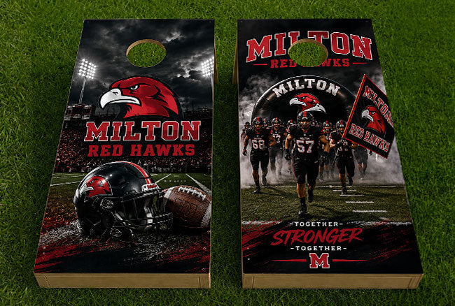A pair of custom cornhole boards featuring the Milton Red Hawks football team design, displayed on a green grass background. The boards feature a dark, dramatic football field scene with a red hawk logo, team players, a helmet, and a football, along with the text 'MILTON RED HAWKS' and 'TOGETHER STRONGER TOGETHER'.