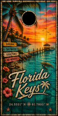 A rustic wooden-style sign or poster featuring a tropical Florida Keys sunset scene with palm trees, turquoise water, a pier, a turtle, flowers, directional signposts, and large stylized text reading 'Florida Keys' with coordinates at the bottom.
