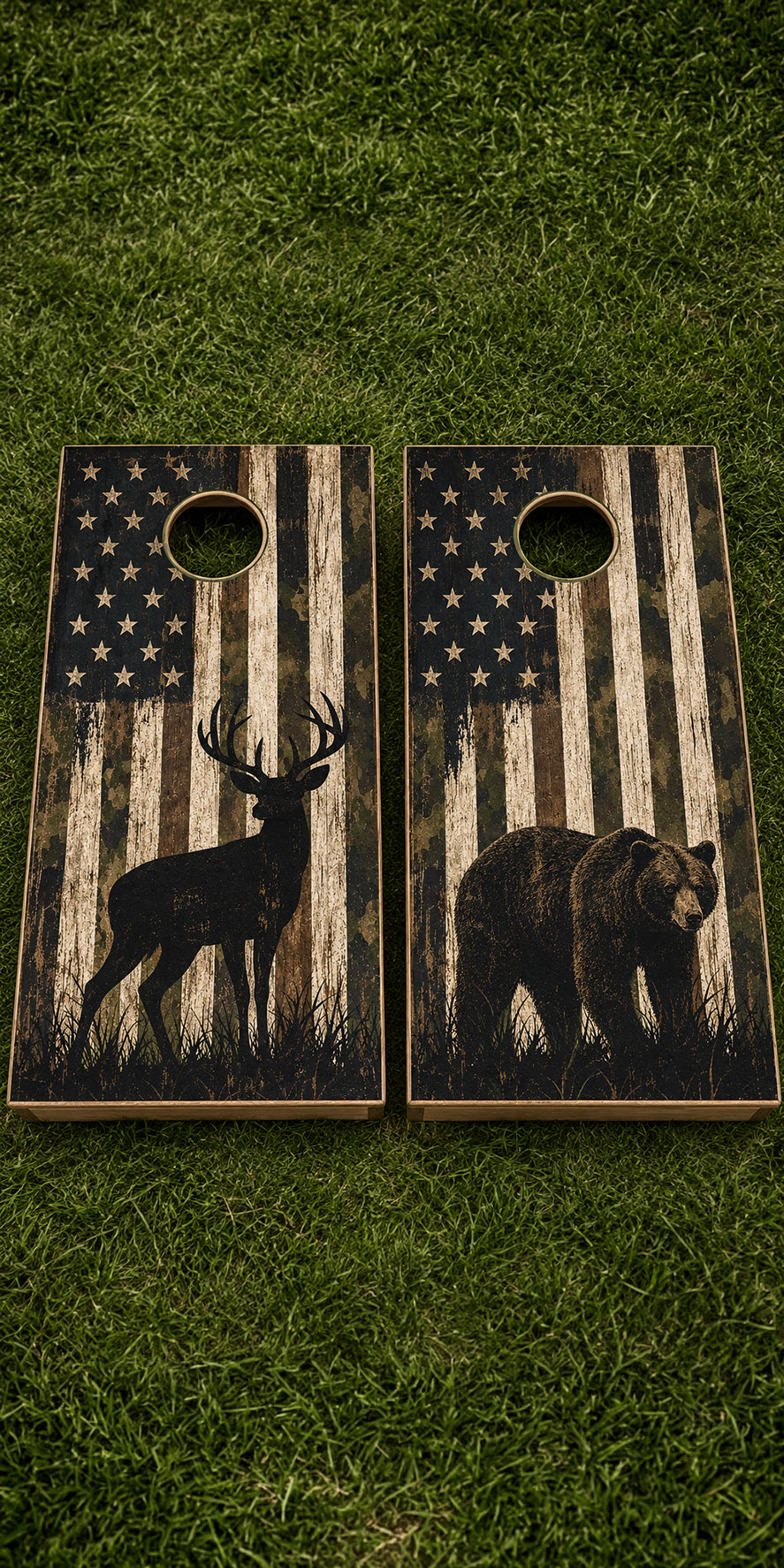 Two rustic cornhole boards placed on green grass. Each board has a circular hole and features a distressed American flag design with a black deer silhouette on one board and a black bear silhouette on the other.